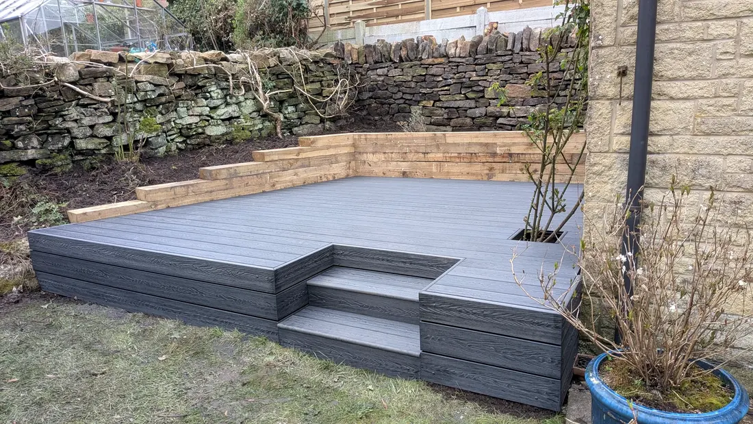 A raised composite deck with built-in steps by Pete Hughes Property Services